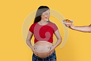 Male Hand Offering Plate With Croissant To Happy Pregnant Lady