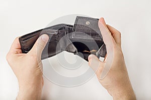 Male hand opening a wallet and count coins money on white background. World economic crisis. Financial problem jobless,