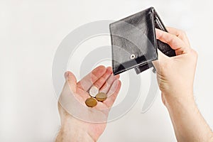 Male hand opening a wallet and count coins money on white background. World economic crisis. Financial problem jobless,