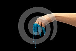 Male hand painted blue gesturing isolated on dark studio background. Concept of human relation, symbolism, culture and