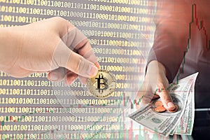 Male hand picking physical version of Bitcoin new virtual money