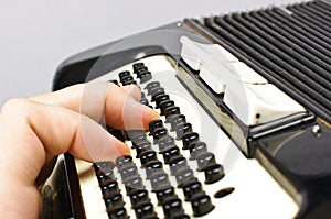 Male hand playing accordion