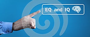 Male hand pointing Eq and Iq word