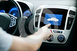 Male hand pointing finger to car icon on panel