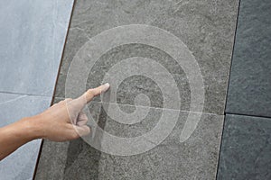 Male hand pointing at stone tile choosing sample material