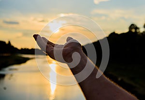 Male hand pointing at sun in blue sky at evening time admire landscape. Capture moment to admire sunset nature beauty