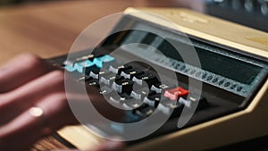 Male Hand Press Buttons on an Old Retro Calculating Machine Close-Up