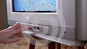 A Male Hand Presses the Buttons with Finger on Old Vintage TV with Interference