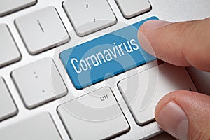 Male hand pressing computer keyboard coronavirus button photo
