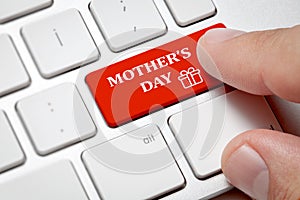 Male hand pressing Mother`s Day button on computer keyboard