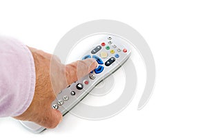 Male hand pressing silver remote control on white with copy-space