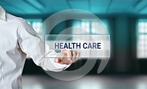Male hand pressing the word health care on a virtual search screen