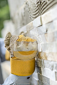 Male hand in protective work glove making a fist while pressing