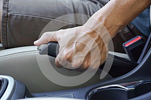 Male hand pulling a parking brake