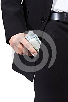 Male hand puts money into his trouser pocket