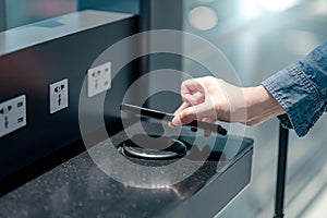 Male hand putting smartphone on wireless charger