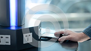 Male hand putting smartphone on wireless charger