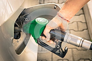 Male Hand refilling Gas at Fuel Station
