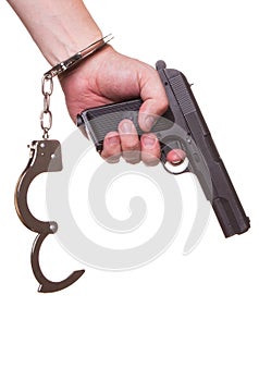 Male hand robber in handcuffs with a gun isolated on a white background