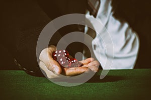 Male hand rolling five dice