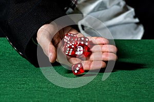 Male hand rolling five dice