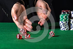 Male hand rolling five dice
