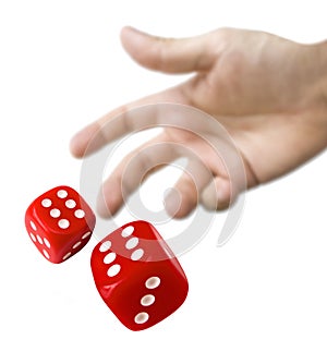 Male hand rolling red dice photo