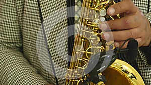 Male hand and saxophone. Man playing sax. Jazz as an art