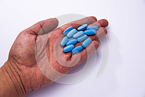 Male hand showing a bunch of blue pills photo