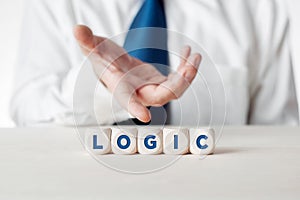 Male hand showing the word logic written on wooden cubes. Business logical decision or using logic