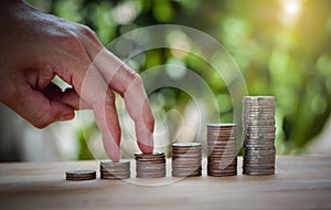 Male hand stack coins same stair for the first step like growing for the future, education, home, loan and child