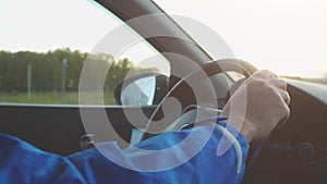 Male Hand on steering wheel close up. Man driving his car