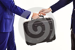 Male hand in suits hold black briefcase.