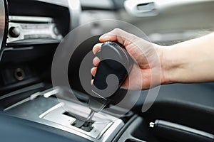 The male hand and switches the transmission