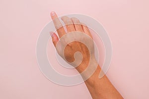 Male hand touching with one finger  on pink background. Hands to operate the touch panel