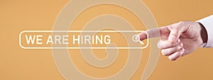 Male hand touching search button. We Are Hiring. Recruiting and Employment