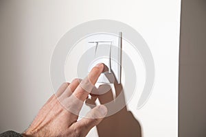 Male hand turning off or on light switch