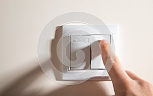 Male hand turning off or on light switch