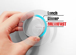 Male hand turns the switch. Switches mealtimes. Chose the Breakfast