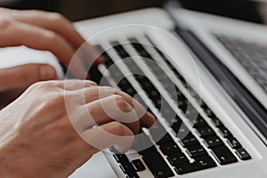 Male hand typing on keyboard concept.