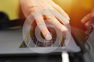 Male hand typing on the keyboard a laptop. working man programmer. work from home. workplace with a laptop.