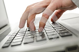Male hand typing on laptop
