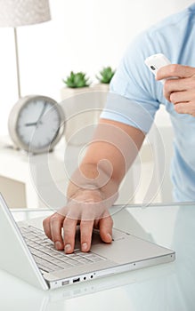 Male hand typing on laptop computer