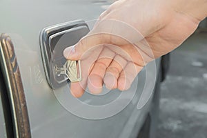 Male hand unlocking old used car door