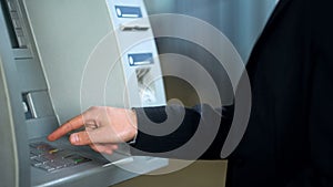 Male hand using ATM, typing pin code and pressing cancel button, system error
