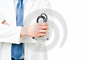 Male hand using a medical stethoscope at the office
