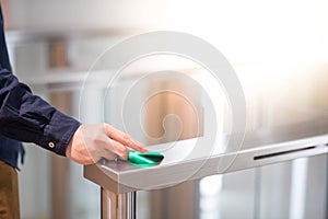 Male hand using smart card to open automatic gate machine