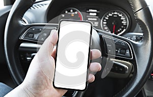 Male hand using smartphone in car. Man driving a car. Smartphone in a car use for Navigate or GPS. Mobile phone with isolated