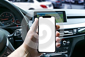 Male hand using smartphone in car. Man driving a car. Smartphone in a car use for Navigate or GPS. Mobile phone with isolated whit