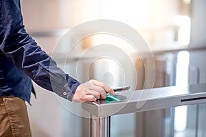 Male hand using smartphone to open automatic gate machine